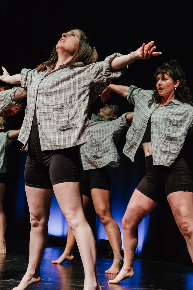 QTC dancers arms extended on stage