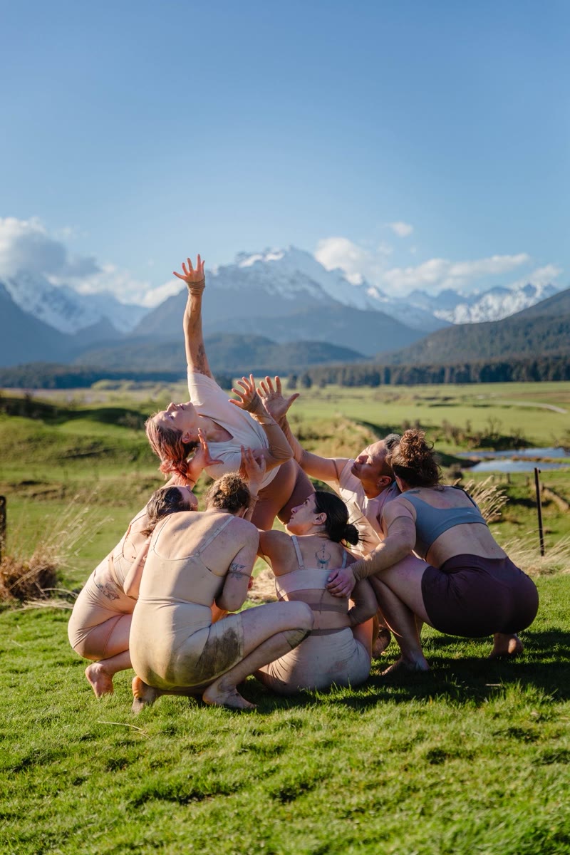 QTC huddle with mountain backdrop
