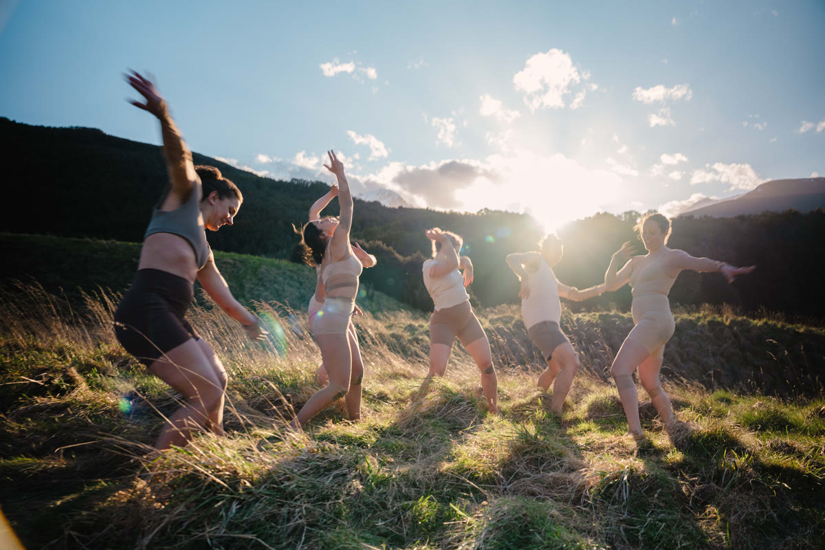 QTC dancers in golden field at sunset
